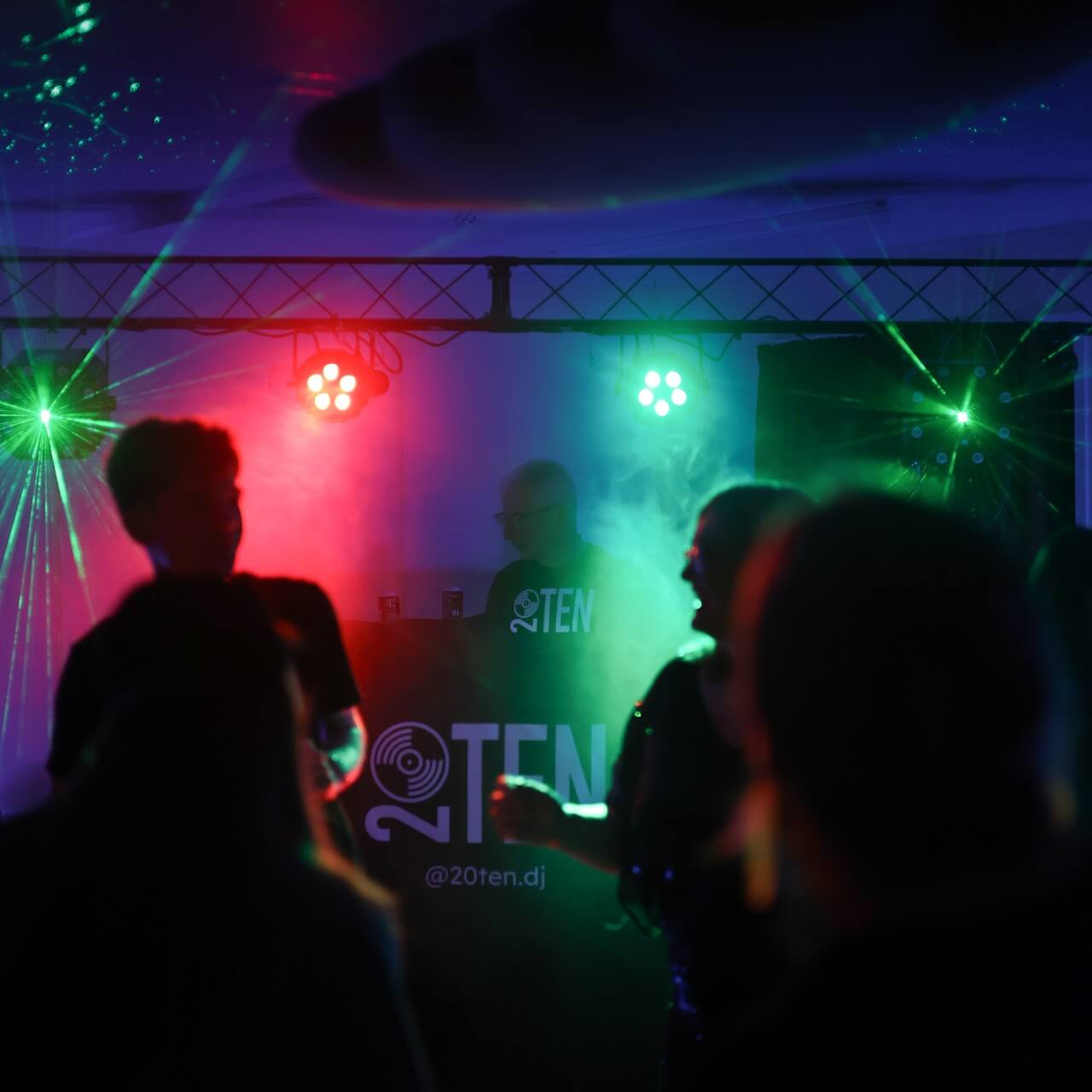Dancefloor crowd celebrating with mobile disco entertainment setup