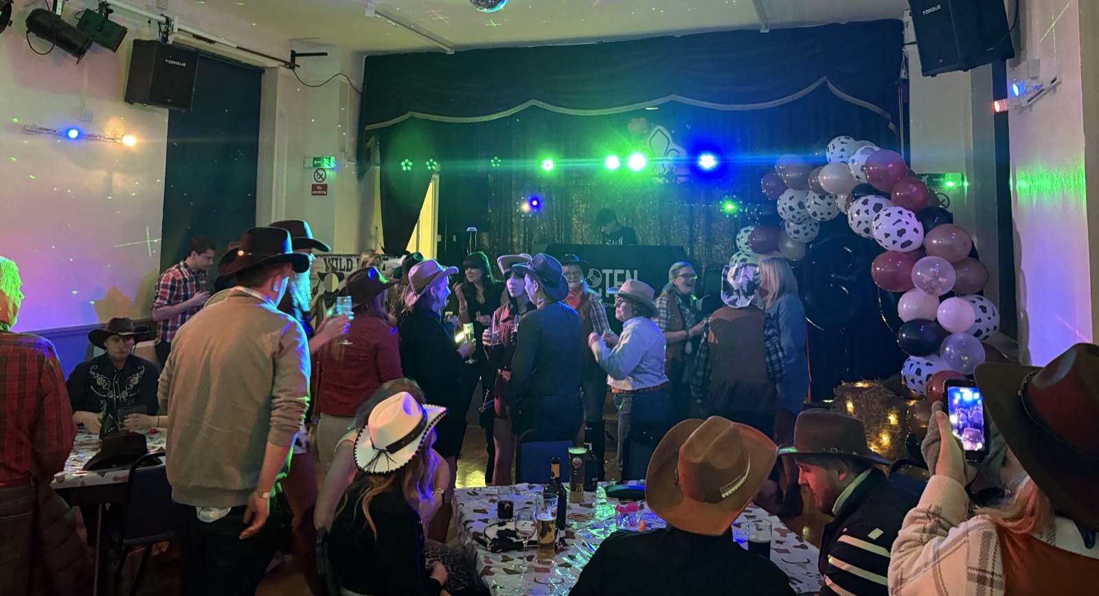 Vibrant dancefloor crowd with professional party lighting display