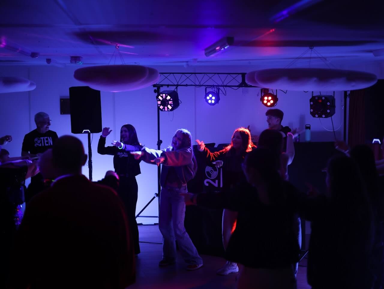 Rustic barn wedding DJ entertainment setup with elegant low-profile booth